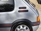 a small silver car that is parked in a parking lot