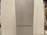 a silver refrigerator sitting on a pallet in a warehouse