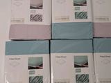 four boxes of blue and white sheets stacked on top of each other