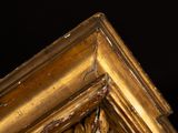 a gold frame with a clock on top of it