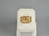 an image of a gold signet ring on a white stand