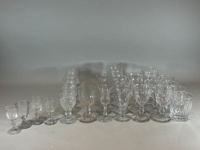 a lot of glasses and cups sitting on a table
