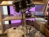 a drum set up on top of a table in a room