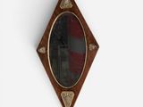 a mirror hanging on the wall with a flag in the background
