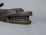 a wooden sculpture of a dog ' s head on a table