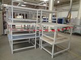 many shelves that are in a warehouse with red and white tape