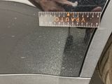 a close up of a measuring tape on the side of a car