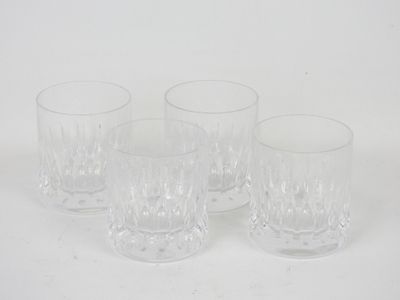 four clear glass tumblers sitting on a white surface