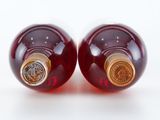 two bottles of wine sitting next to each other on a table