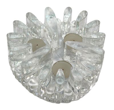 a glass candle holder with two candles inside of it