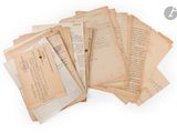 several old papers are stacked on top of each other on a white surface