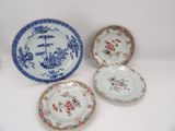 three plates with floral designs on them sitting on a table