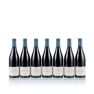 six bottles of red wine lined up in a row