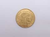 a close up of a gold coin on a white surface