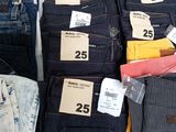 a lot of jeans that are on display in a store