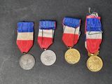 three medals and a medal on a table with a black background
