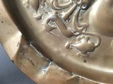 a gold plate with a picture of a man and a woman on it