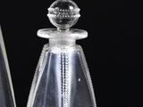 two clear vases sitting next to each other on a table