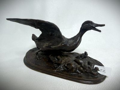 bronze sculpture of a duck and ducklings on a wooden base
