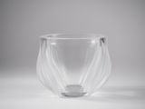 clear glass vase with wavy design on a white surface