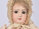 a doll that is wearing a bonnet and a dress
