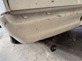 a cat that is laying under a car on the ground