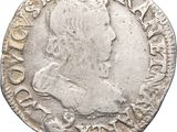 une pièce d'argent portant l'image d'un homme