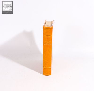 an orange book that is sitting on a white surface