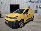 a yellow van parked in front of a building in a parking lot