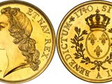 a close up of a gold coin with a crown on it