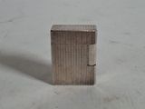 an image of a small metal object on a white surface