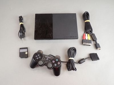 a video game console and a charger on a table