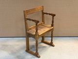 a wooden chair that is sitting in front of a wall