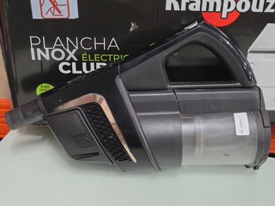 a black and silver vacuum on a table next to a box of krampozzi