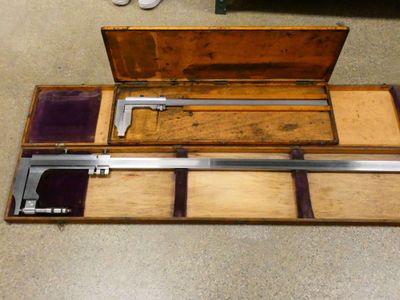 a wooden box with a pair of tools inside of it