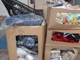 two boxes of clothes and a chair in a warehouse