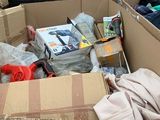 a cardboard box full of clothes and other items in it