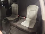 two seats in the back of a car with a remote control