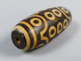an image of a wooden bead with black and yellow designs