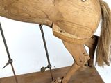 un cheval en bois posé sur un socle en bois