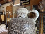 a large vase sitting on a table in a room