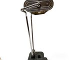 a metal lamp that is on top of a table