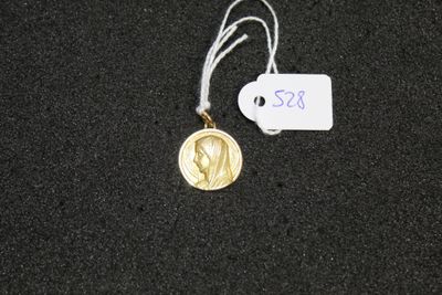 a gold medal with a white tag attached to it
