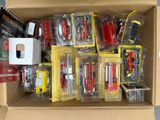 a cardboard box filled with various types of toy vehicles