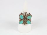 a close up of a ring with turquoise stones on it