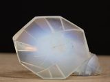 a clear glass object sitting on top of a wooden table