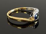an image of a gold ring with a blue stone