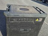 a trash can sitting in the middle of a parking lot