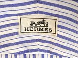 a close up of a blue and white striped shirt with a logo on it