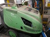 a green machine that is sitting on the floor
